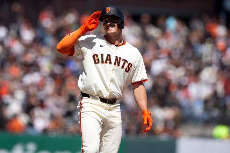 May 18, 2024; San Francisco, California, USA; San Francisco Giants third baseman Matt Chapman (26) salutes his teammates after winding up at third base on a double and an error by the Colorado Rockies during the seventh inning at Oracle Park. Mandatory Credit: D. Ross Cameron-USA TODAY Sports