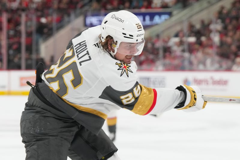 Oct 28, 2025; Raleigh, North Carolina, USA;  Vegas Golden Knights right wing Alexander Holtz (26) takes a shot against the Carolina Hurricanes during the second period at Lenovo Center. Mandatory Credit: James Guillory-Imagn Images