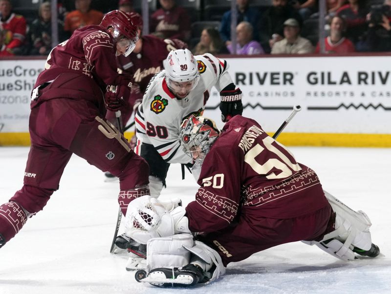 Mar 18, 2023; Tempe, Arizona, USA; Arizona Coyotes goaltender Ivan Prosvetov (50) makes a save against Chicago Blackhawks center Tyler Johnson (90) during the first period at Mullett Arena. Mandatory Credit: Joe Camporeale-USA TODAY Sports