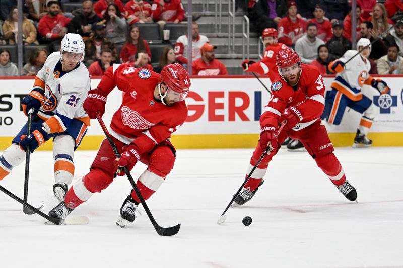 Nov 21, 2024; Detroit, Michigan, USA; Detroit Red Wings center Tyler Motte (14) and left wing J.T. Compher (37) try to get control of the puck in front of New York Islanders center Brock Nelson (29) in the third period at Little Caesars Arena. Mandatory Credit: Lon Horwedel-Imagn Images