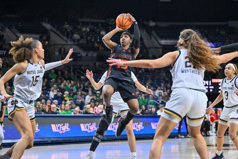 Jan 14, 2024; South Bend, Indiana, USA; Miami Hurricanes guard Lashae Dwyer (13) goes up for a shot as Notre Dame Fighting Irish forward Nat Marshall (15) and forward Maddy Westbeld (21) defend in the second half at the Purcell Pavilion. Mandatory Credit: Matt Cashore-USA TODAY Sports