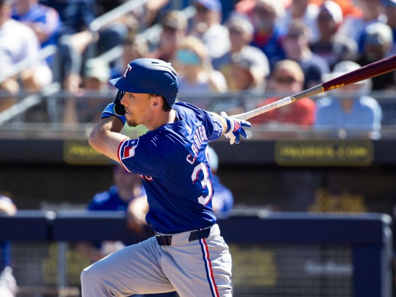 Mar 5, 2024; Peoria, Arizona, USA; Texas Rangers outfielder Evan Carter hits a home run against the Seattle Mariners during a spring training baseball game at Peoria Sports Complex. Mandatory Credit: Mark J. Rebilas-USA TODAY Sports