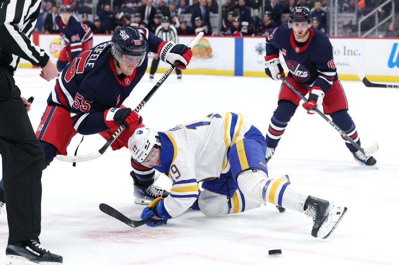 Mar 23, 2025; Winnipeg, Manitoba, CAN; Winnipeg Jets center Mark Scheifele (55) and Buffalo Sabres center Peyton Krebs (19) face off in the second period at Canada Life Centre. Mandatory Credit: James Carey Lauder-Imagn Images