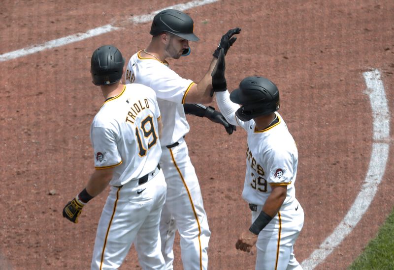 May 23, 2024; Pittsburgh, Pennsylvania, USA; Pittsburgh Pirates catcher Joey Bart (middle) celebrates hitting a grand slam with third baseman Jared Triolo (19) and second baseman Nick Gonzales (39) against the San Francisco Giants during the fourth inning at PNC Park. Mandatory Credit: Charles LeClaire-USA TODAY Sports