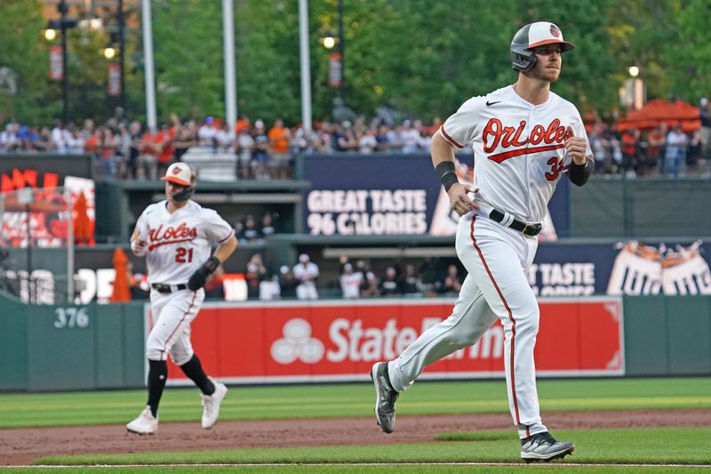 Jul 30, 2023; Baltimore, Maryland, USA; Baltimore Orioles first baseman Ryan O   Hearn (32) and outfielder Austin Hays (21) round the bases to score on outfielder Adam Frazier   s (not shown) three-run home run in the first inning against the New York Yankees at Oriole Park at Camden Yards. Mandatory Credit: Mitch Stringer-USA TODAY Sports