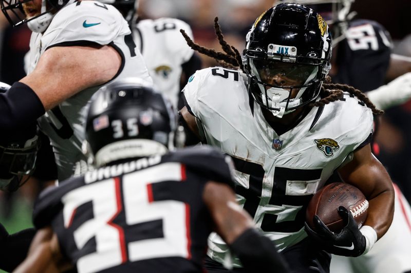 Jacksonville Jaguars running back Gary Brightwell (35) runs toward Atlanta Falcons cornerback Natrone Brooks (35) in the second half of an NFL preseason footballl game, Friday, Aug. 23, 2024, in Atlanta. (AP Photo/Butch Dill)