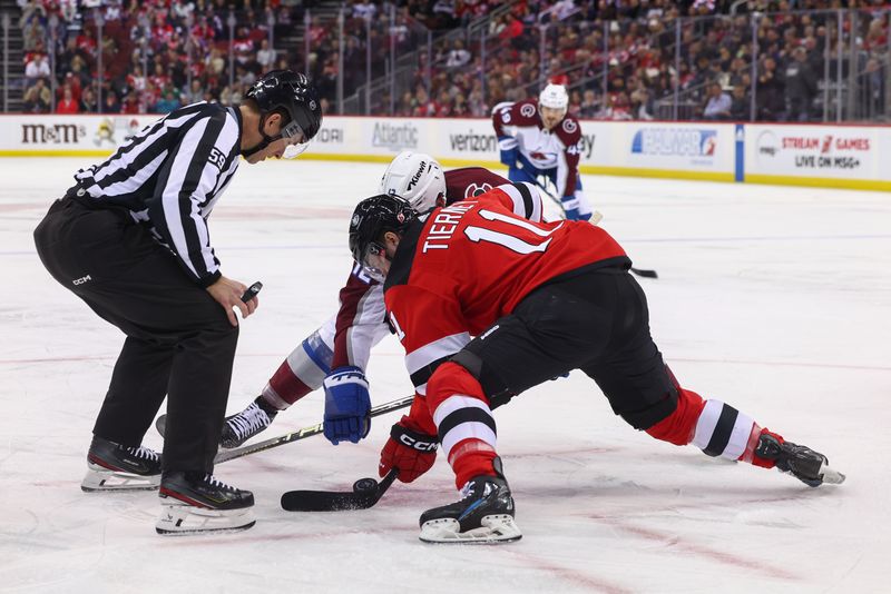 Feb 6, 2024; Newark, New Jersey, USA; New Jersey Devils center Chris Tierney (11) and Colorado Avalanche center Ryan Johansen (12) face-off during the first period at Prudential Center. Mandatory Credit: Ed Mulholland-USA TODAY Sports