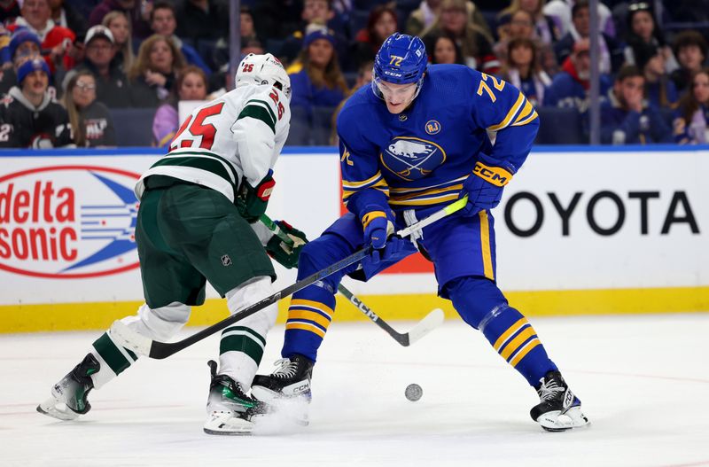 Nov 10, 2023; Buffalo, New York, USA;  Minnesota Wild defenseman Jonas Brodin (25) and Buffalo Sabres right wing Tage Thompson (72) looks to control a loose puck during the second period at KeyBank Center. Mandatory Credit: Timothy T. Ludwig-USA TODAY Sports