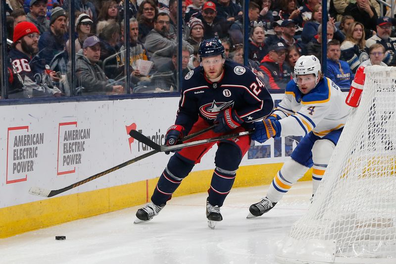 Apr 10, 2025; Columbus, Ohio, USA; Columbus Blue Jackets center Mathieu Olivier (24) and Buffalo Sabres defenseman Bowen Byram (4) skate after a loose puck during the second period at Nationwide Arena. Mandatory Credit: Russell LaBounty-Imagn Images