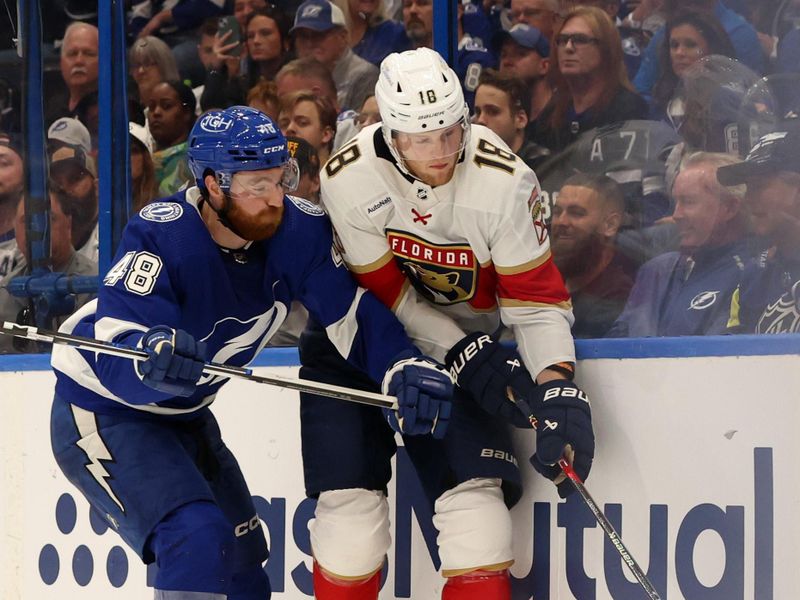 Apr 25, 2024; Tampa, Florida, USA; Tampa Bay Lightning defenseman Nick Perbix (48) defends Florida Panthers center Steven Lorentz (18) during the second period in game three of the first round of the 2024 Stanley Cup Playoffs at Amalie Arena. Mandatory Credit: Kim Klement Neitzel-USA TODAY Sports