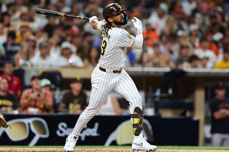 Sep 7, 2024; San Diego, California, USA; San Diego Padres pinch hitter Fernando Tatis Jr. (23) hits a double against the San Francisco Giants during the ninth inning at Petco Park. Mandatory Credit: Chadd Cady-Imagn Images