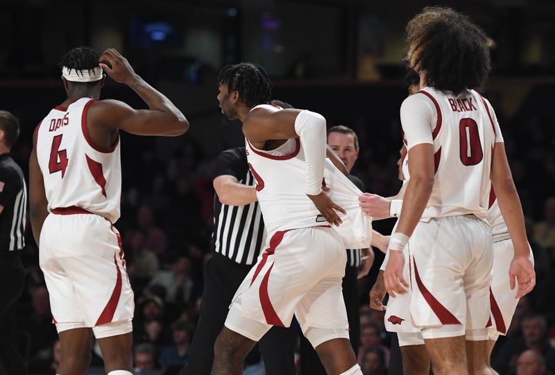 Jan 14, 2023; Nashville, Tennessee, USA; Arkansas Razorbacks forward Kamani Johnson (20) is held back by teammates after a play against the Vanderbilt Commodores during the first half at Memorial Gymnasium. Mandatory Credit: Christopher Hanewinckel-USA TODAY Sports