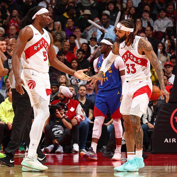 TORONTO, CANADA - DECEMBER 20: Precious Achiuwa #5 and Gary Trent Jr. #33 of the Toronto Raptors high five during the game against the Denver Nuggets on December 20, 2023 at the Scotiabank Arena in Toronto, Ontario, Canada.  NOTE TO USER: User expressly acknowledges and agrees that, by downloading and or using this Photograph, user is consenting to the terms and conditions of the Getty Images License Agreement.  Mandatory Copyright Notice: Copyright 2023 NBAE (Photo by Vaughn Ridley/NBAE via Getty Images)