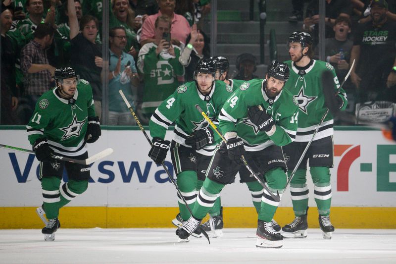 May 25, 2024; Dallas, Texas, USA; Dallas Stars center Logan Stankoven (11) and left wing Jamie Benn (14) and d42 and center Wyatt Johnston (53) a d defenseman Thomas Harley (55) celebrates a goal scored by Benn against the Edmonton Oilers during the first period in game two of the Western Conference Final of the 2024 Stanley Cup Playoffs at American Airlines Center. Mandatory Credit: Jerome Miron-USA TODAY Sports