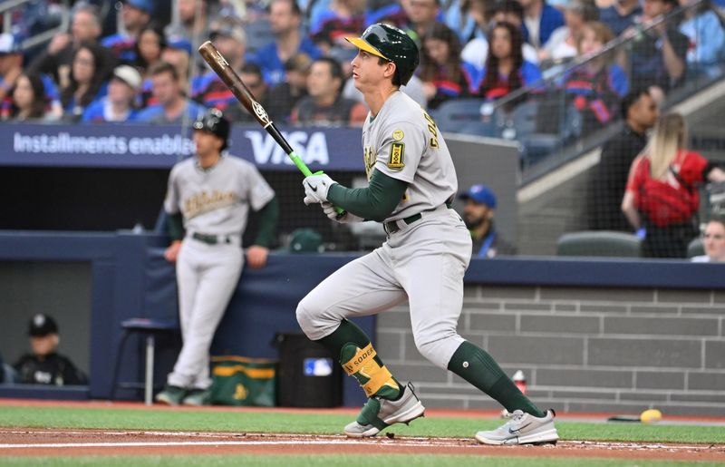 May 30, 2025; Toronto, Ontario, CAN;  Athletics first baseman Tyler Soderstrom (21) hits a solo home run against the Toronto Blue Jays in the second inning at Rogers Centre. Mandatory Credit: Dan Hamilton-Imagn Images