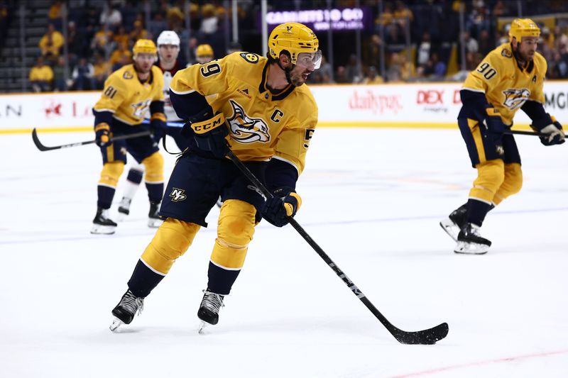 Oct 26, 2024; Nashville, Tennessee, USA; Nashville Predators defenseman Roman Josi (59) controls the puck against the Columbus Blue Jackets in the first period at Bridgestone Arena. Mandatory Credit: Casey Gower-Imagn Images