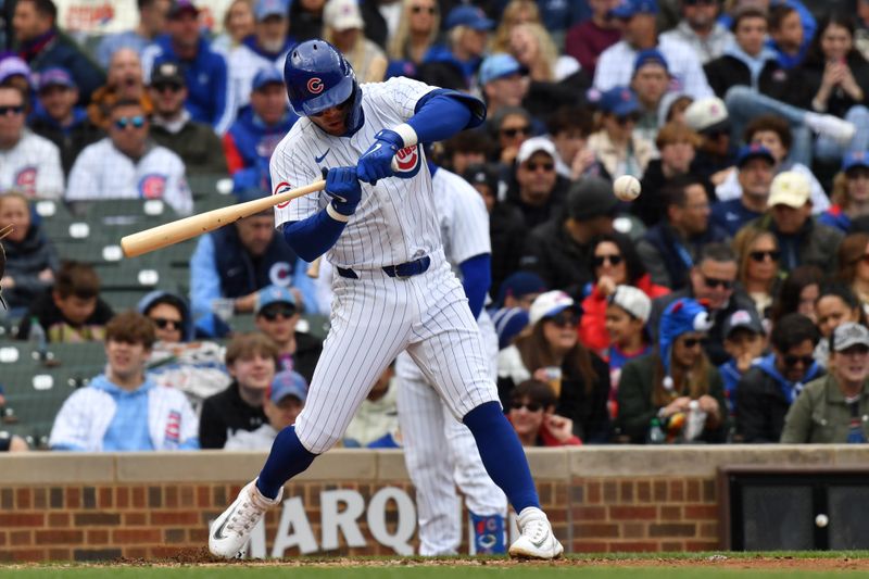 Apr 20, 2024; Chicago, Illinois, USA; Chicago Cubs second baseman Nico Hoerner (2) hits a single during the third inning against the Miami Marlins at Wrigley Field. Mandatory Credit: Patrick Gorski-USA TODAY Sports