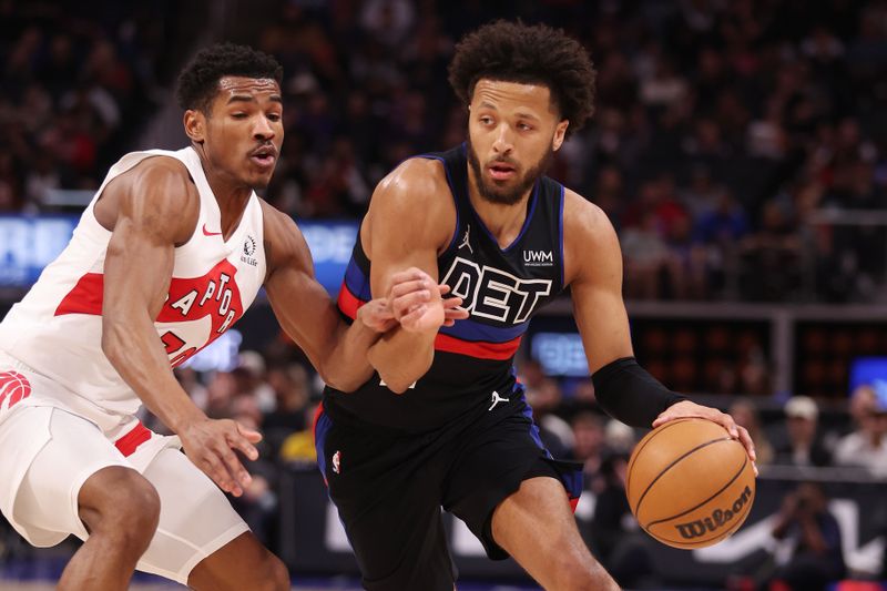 DETROIT, MICHIGAN - MARCH 13: Cade Cunningham #2 of the Detroit Pistons drives around Ochai Agbaji #30 of the Toronto Raptors during the first half at Little Caesars Arena on March 13, 2024 in Detroit, Michigan. NOTE TO USER: User expressly acknowledges and agrees that, by downloading and or using this photograph, User is consenting to the terms and conditions of the Getty Images License.  (Photo by Gregory Shamus/Getty Images)