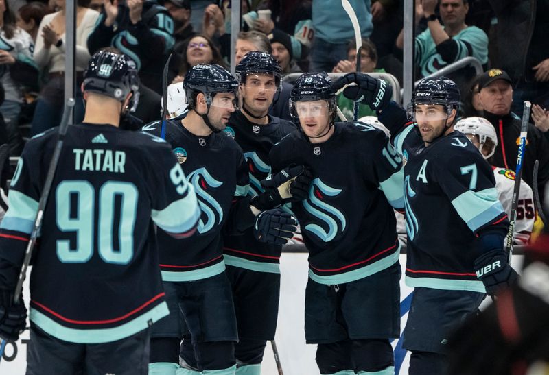 Jan 24, 2024; Seattle, Washington, USA; Seattle Kraken forward Jared McCann (19), second from right, is congratulated by forward Jordan Eberle (7), forward Tomas Tatar (90), defenseman Justin Schultz (4), second from left, and defenseman Brian Dumoulin (8) after scoring a goal against the Chicago Blackhawks during the first period at Climate Pledge Arena. Mandatory Credit: Stephen Brashear-USA TODAY Sports