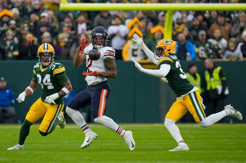 Chicago Bears' DJ Moore catches a pass between Green Bay Packers' Jonathan Owens and Carrington Valentine during the first half of an NFL football game Sunday, Jan. 7, 2024, in Green Bay, Wis. (AP Photo/Morry Gash)