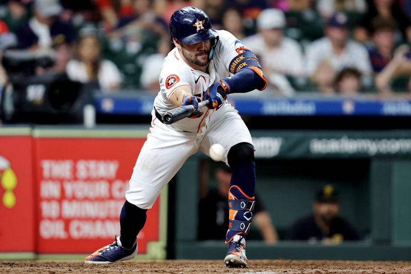 Jul 31, 2024; Houston, Texas, USA; Houston Astros right fielder Chas McCormick (20) bunts against the Pittsburgh Pirates during the seventh inning at Minute Maid Park. Mandatory Credit: Erik Williams-USA TODAY Sports