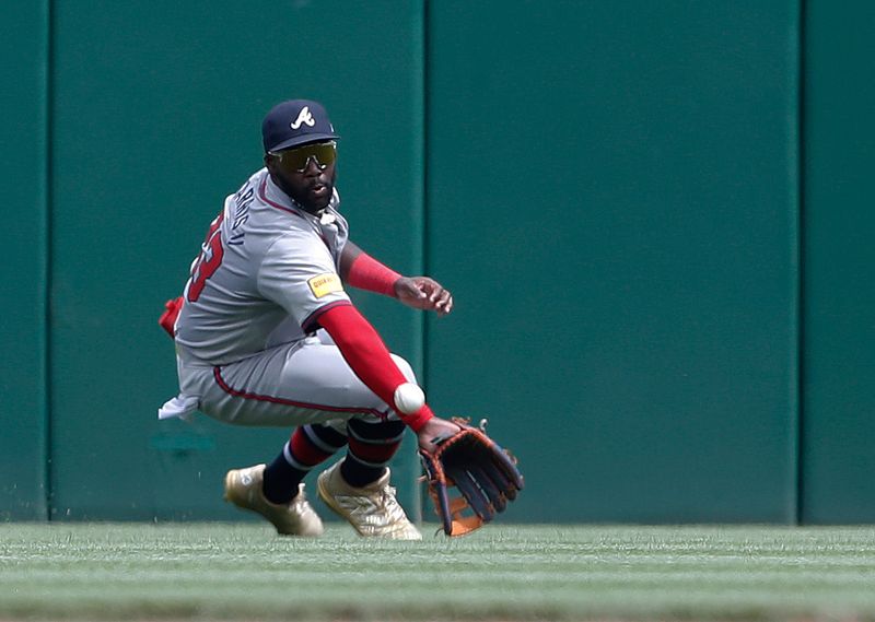 May 26, 2024; Pittsburgh, Pennsylvania, USA;  Atlanta Braves center fielder Michael Harris II (23) attempts to catch a ball hit for a single by Pittsburgh Pirates left fielder Bryan Reynolds (not pictured) during the sixth inning against at PNC Park. The ball was ruled to be trapped. Mandatory Credit: Charles LeClaire-USA TODAY Sports