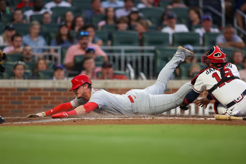 Sep 7, 2023; Atlanta, Georgia, USA; St. Louis Cardinals second baseman Nolan Gorman (16) scores past Atlanta Braves catcher Travis d'Arnaud (16) in the second inning at Truist Park. Mandatory Credit: Brett Davis-USA TODAY Sports