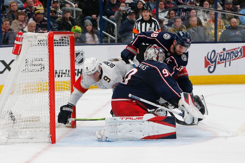 Mar 20, 2025; Columbus, Ohio, USA; Columbus Blue Jackets center Boone Jenner (38) checks Florida Panthers center Sam Bennett (9) during the third period at Nationwide Arena. Mandatory Credit: Russell LaBounty-Imagn Images