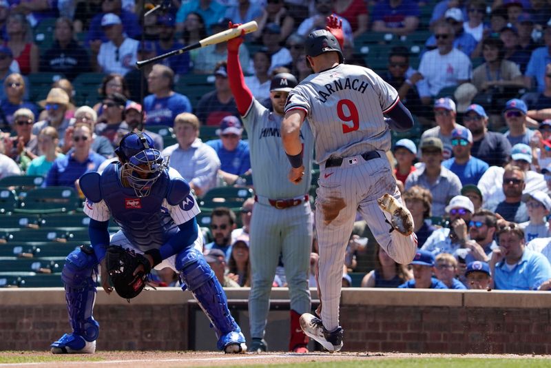 Aug 7, 2024; Chicago, Illinois, USA; Minnesota Twins outfielder Trevor Larnach (9)  scores against Chicago Cubs catcher Christian Bethancourt (60) during the first inning at Wrigley Field. Mandatory Credit: David Banks-USA TODAY Sports