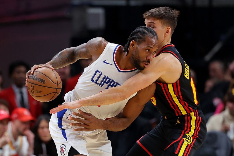 ATLANTA, GEORGIA - FEBRUARY 05:  Kawhi Leonard #2 of the LA Clippers is defended by Bogdan Bogdanovic #13 of the Atlanta Hawks during the first quarter at State Farm Arena on February 05, 2024 in Atlanta, Georgia.  NOTE TO USER: User expressly acknowledges and agrees that, by downloading and/or using this photograph, user is consenting to the terms and conditions of the Getty Images License Agreement.  (Photo by Kevin C. Cox/Getty Images)