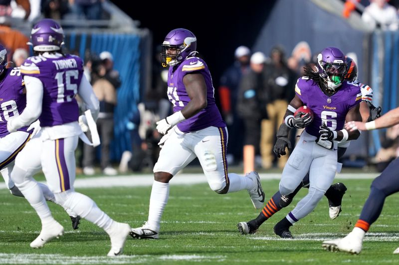 Minnesota Vikings linebacker Brian Asamoah II (6) runs back after recovering the ball on a blocked field goal attempt during the first half of an NFL football game against the Chicago Bears, Sunday, Nov. 24, 2024, in Chicago. (AP Photo/Charles Rex Arbogast)