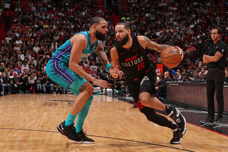 MIAMI, FL - JANUARY 14: Caleb Martin #16 of the Miami Heat handles the ball during the game against the Charlotte Hornets on January 14, 2024 at Kaseya Center in Miami, Florida. NOTE TO USER: User expressly acknowledges and agrees that, by downloading and or using this Photograph, user is consenting to the terms and conditions of the Getty Images License Agreement. Mandatory Copyright Notice: Copyright 2024 NBAE (Photo by Issac Baldizon/NBAE via Getty Images)