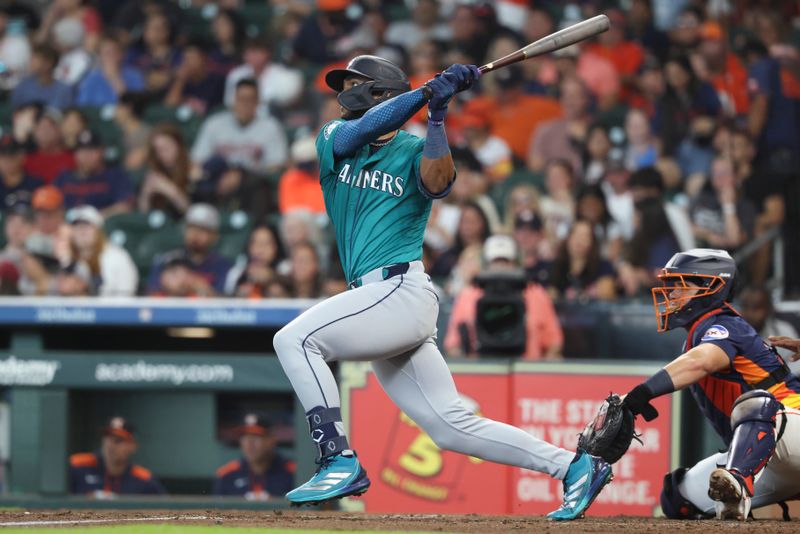May 25, 2025; Houston, Texas, USA; Seattle Mariners center fielder Julio Rodriguez (44) hits a single during the third inning against the Houston Astros at Daikin Park. Mandatory Credit: Troy Taormina-Imagn Images