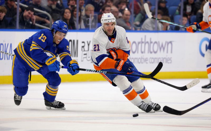 Mar 14, 2024; Buffalo, New York, USA;  Buffalo Sabres center Peyton Krebs (19) defends as New York Islanders center Kyle Palmieri (21) passes the puck during the first period at KeyBank Center. Mandatory Credit: Timothy T. Ludwig-USA TODAY Sports