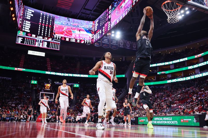 HOUSTON, TEXAS - NOVEMBER 22: Tari Eason #17 of the Houston Rockets dunks as Jabari Walker #34 of the Portland Trail Blazers looks on during the second half in the NBA Emirates Cup at Toyota Center on November 22, 2024 in Houston, Texas.  NOTE TO USER: User expressly acknowledges and agrees that, by downloading and or using this photograph, User is consenting to the terms and conditions of the Getty Images License Agreement. (Photo by Alex Slitz/Getty Images)
