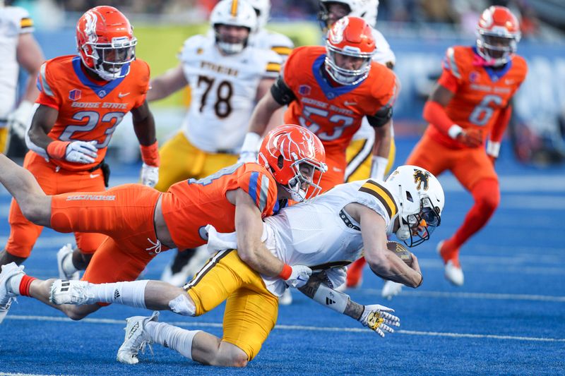 Oct 28, 2023; Boise, Idaho, USA; Boise State Broncos safety Alexander Teubner (34) brings down Wyoming Cowboys quarterback Evan Svoboda (17) during the second half at Albertsons Stadium. Boise State defeats Wyoming 32-7. Mandatory Credit: Brian Losness-USA TODAY Sports

