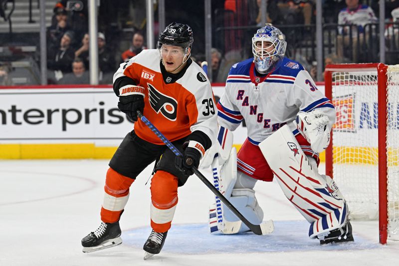 Mar 9, 2026; Philadelphia, Pennsylvania, USA; Philadelphia Flyers right wing Matvei Michkov (39) and New York Rangers goaltender Igor Shesterkin (31) battle for position during the first period at Xfinity Mobile Arena. Mandatory Credit: Eric Hartline-Imagn Images
