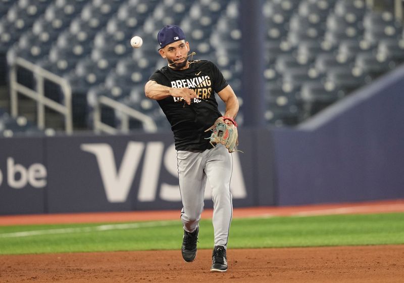 Jul 23, 2024; Toronto, Ontario, CAN; Tampa Bay Rays shortstop Jose Caballero (7) throws a ball to first base during batting practice before a game against the Toronto Blue Jays at Rogers Centre. Mandatory Credit: Nick Turchiaro-USA TODAY Sports