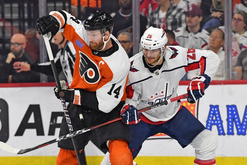 Apr 16, 2024; Philadelphia, Pennsylvania, USA; Philadelphia Flyers center Sean Couturier (14) and Washington Capitals center Nic Dowd (26) battle for position during the second period at Wells Fargo Center. Mandatory Credit: Eric Hartline-USA TODAY Sports