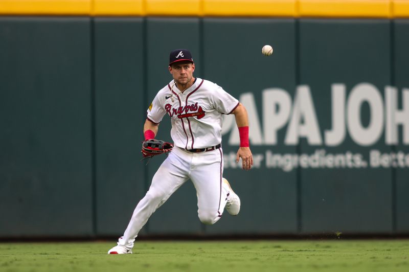 Aug 6, 2024; Atlanta, Georgia, USA; Atlanta Braves center fielder Jarred Kelenic (24) fields a ground ball against the Milwaukee Brewers in the first inning at Truist Park. Mandatory Credit: Brett Davis-USA TODAY Sports
