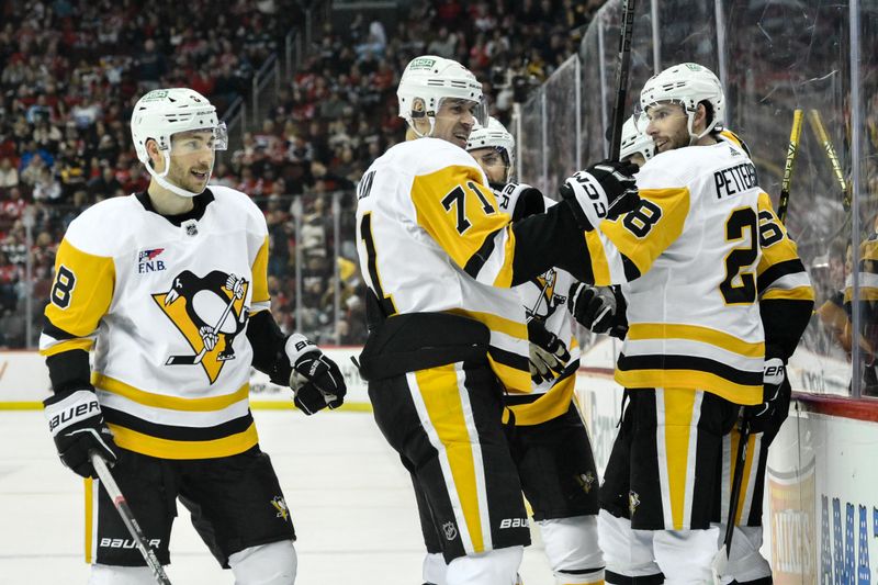 Apr 2, 2024; Newark, New Jersey, USA; Pittsburgh Penguins right wing Rickard Rakell (67) celebrates with teammates after scoring a goal against the New Jersey Devils during the third period at Prudential Center. Mandatory Credit: John Jones-USA TODAY Sports