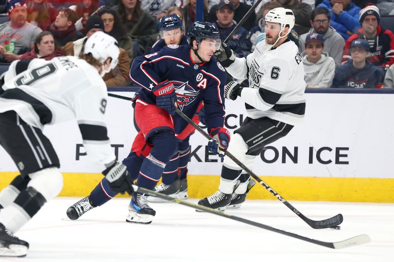Jan 25, 2025; Columbus, Ohio, USA;  Columbus Blue Jackets defenseman Zach Werenski (8) handles the puck as Los Angeles Kings defenseman Joel Edmundson (6) defends during the second period at Nationwide Arena. Mandatory Credit: Joseph Maiorana-Imagn Images