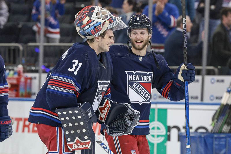 Mar 17, 2024; New York, New York, USA; New York Rangers defenseman Zac Jones (6) celebrates with goaltender Igor Shesterkin (31) after the game against the New York Islanders at Madison Square Garden. Mandatory Credit: Vincent Carchietta-USA TODAY Sports