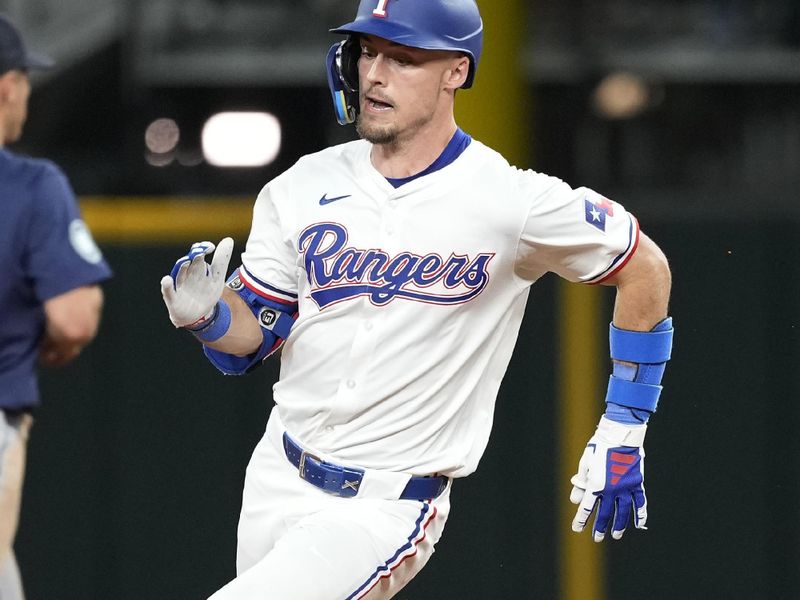 Apr 24, 2024; Arlington, Texas, USA; Texas Rangers left fielder Evan Carter (32) runs to third base on his triple against the Seattle Mariners during the seventh inning at Globe Life Field. Mandatory Credit: Jim Cowsert-USA TODAY Sports