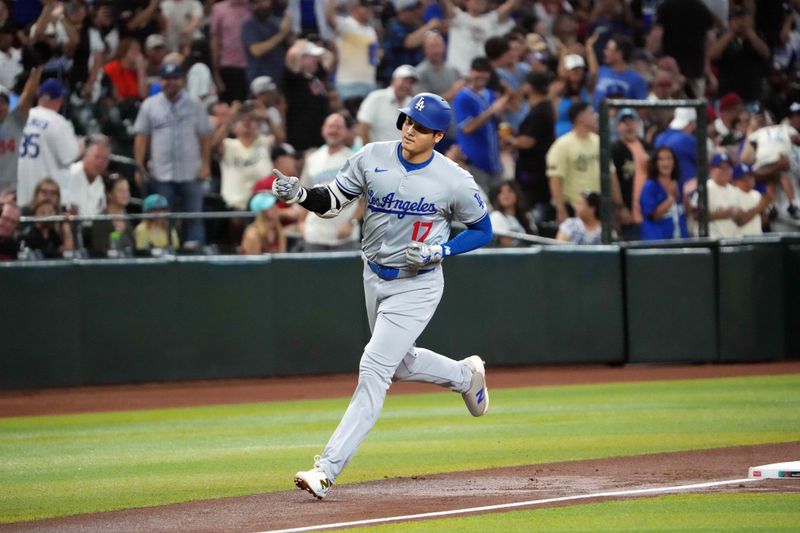Aug 31, 2024; Phoenix, Arizona, USA; Los Angeles Dodgers two-way player Shohei Ohtani (17) runs the bases after hitting a solo home run against the Arizona Diamondbacks during the first inning at Chase Field. Mandatory Credit: Joe Camporeale-USA TODAY Sports
