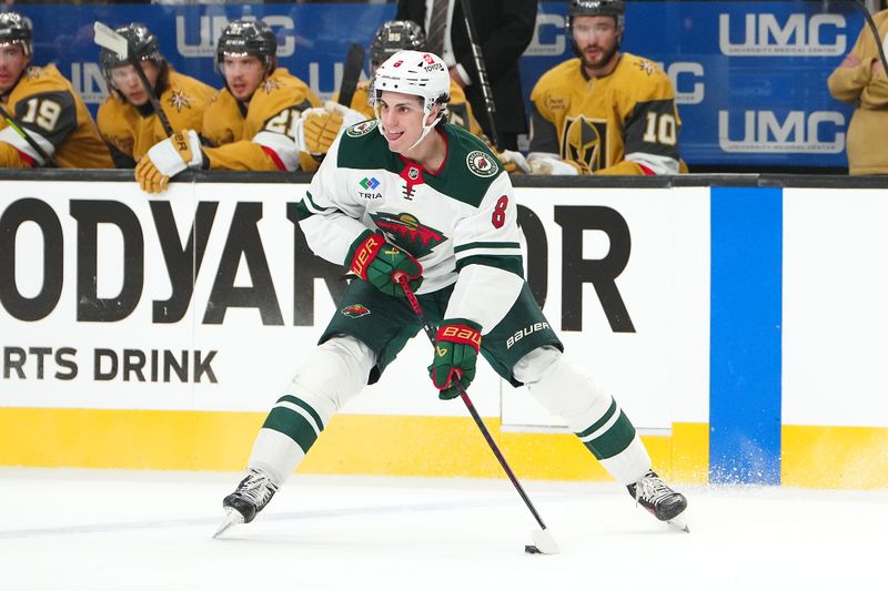 Apr 20, 2025; Las Vegas, Nevada, USA; Minnesota Wild defenseman Zeev Buium (8) skates against the Vegas Golden Knights during the first period of game one of the first round of the 2025 Stanley Cup Playoffs at T-Mobile Arena. Mandatory Credit: Stephen R. Sylvanie-Imagn Images