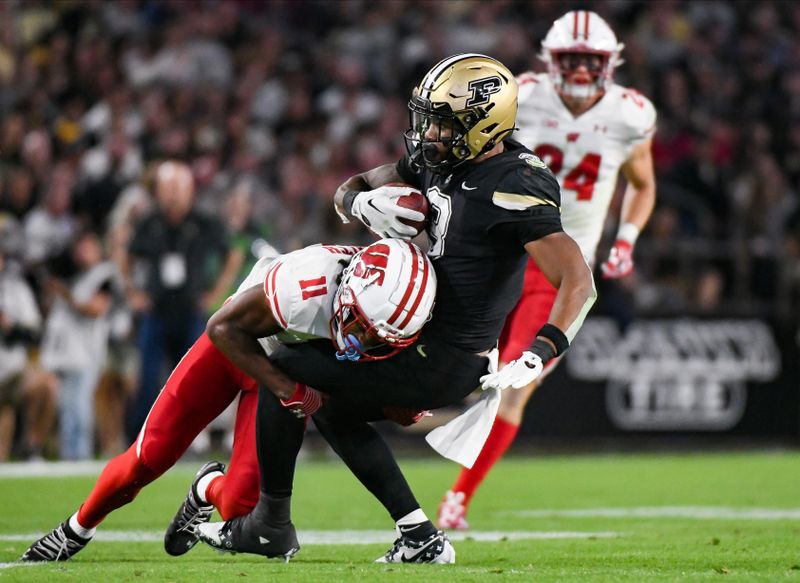 Sep 22, 2023; West Lafayette, Indiana, USA; Wisconsin Badgers cornerback Alexander Smith (11) tackles Purdue Boilermakers running back Tyrone Tracy Jr. (3) during the first half at Ross-Ade Stadium. Mandatory Credit: Robert Goddin-USA TODAY Sports