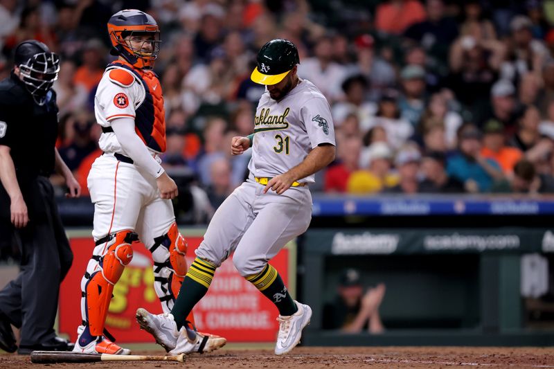 May 14, 2024; Houston, Texas, USA; Oakland Athletics third baseman Abraham Toro (31) crosses home plate to score  a run against the Houston Astros during the eighth inning at Minute Maid Park. Mandatory Credit: Erik Williams-USA TODAY Sports