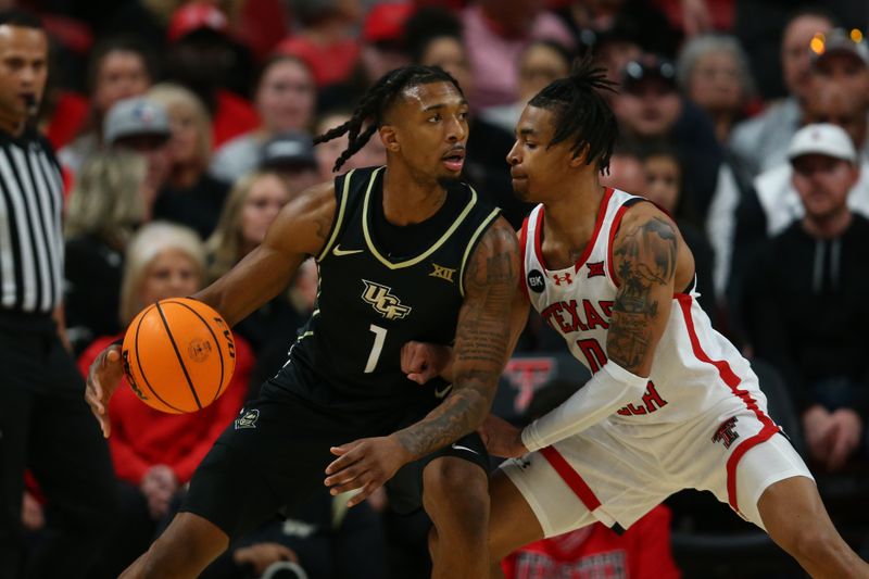 Feb 10, 2024; Lubbock, Texas, USA; Central Florida Knights guard Antwann Jones (1) dribbles the ball against Texas Tech Red Raiders guard Chance McMillian (0) in the first half United Supermarkets Arena. Mandatory Credit: Michael C. Johnson-USA TODAY Sports