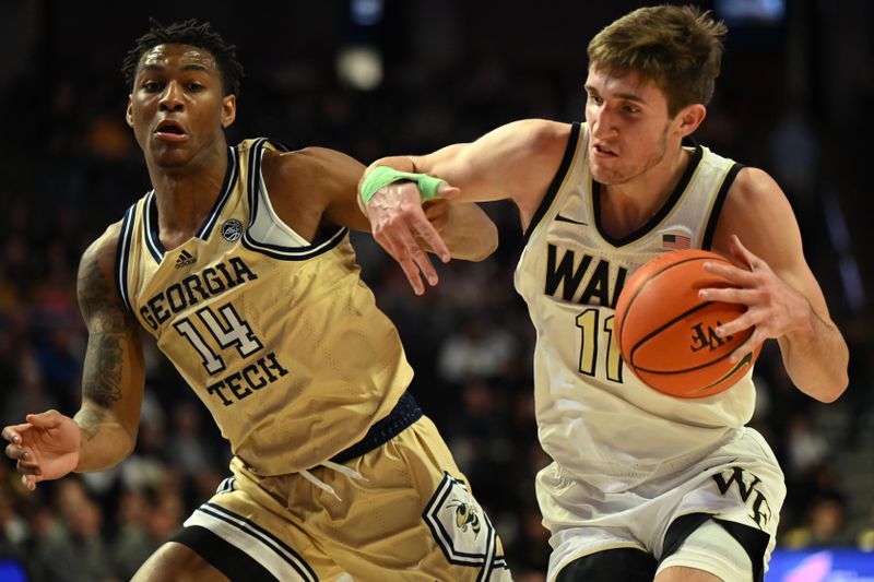 Feb 11, 2023; Winston-Salem, North Carolina, USA; Wake Forest Demon Deacons forward Andrew Carr (11) battles around Georgia Tech Yellow Jackets forward Jalon Moore (14) during the first half at Lawrence Joel Veterans Memorial Coliseum. Mandatory Credit: William Howard-USA TODAY Sports